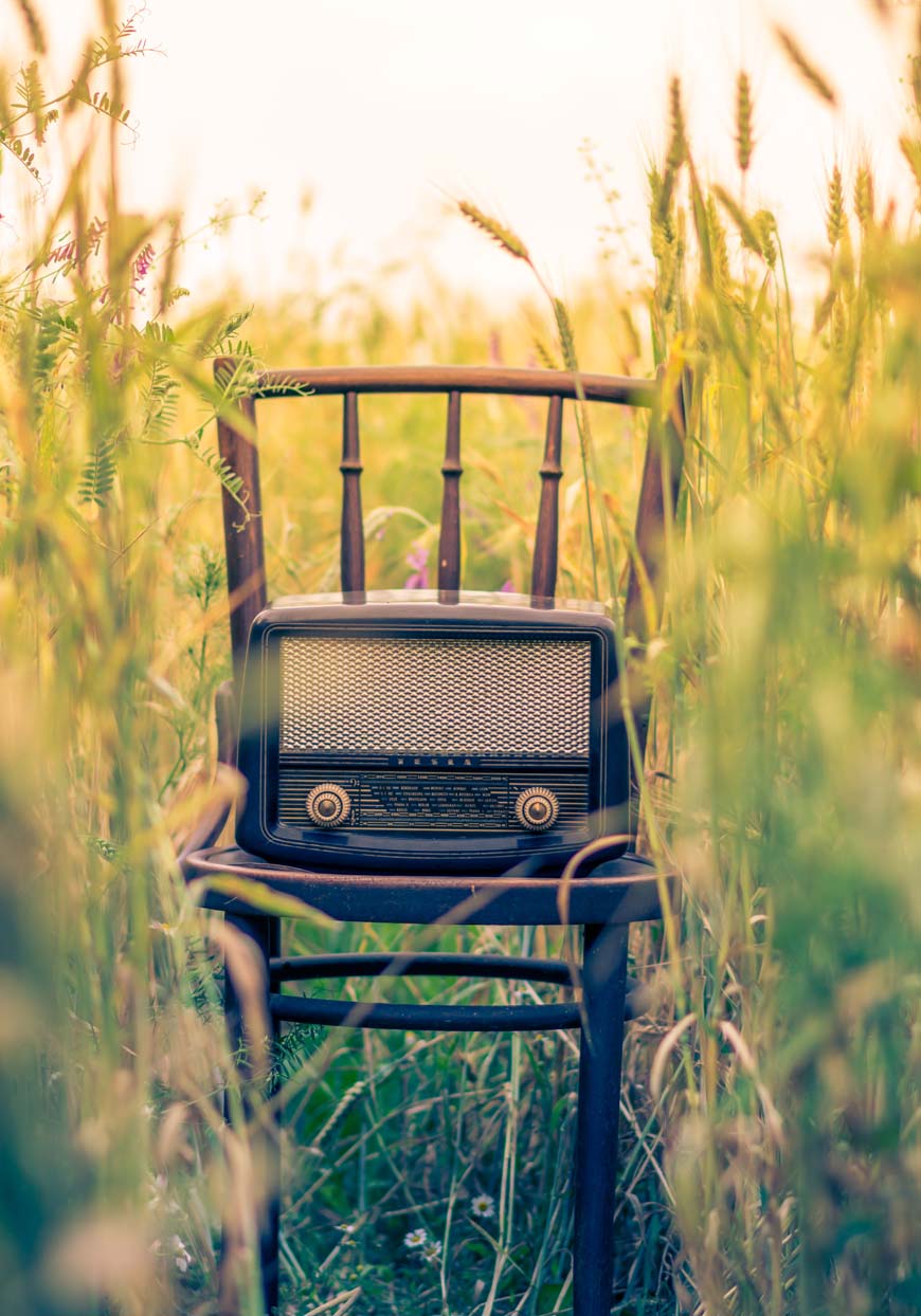chair in a field with a radio on it